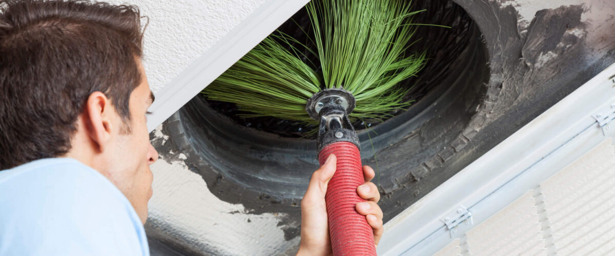 technician performing air duct cleaning