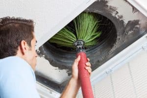 technician performing air duct cleaning