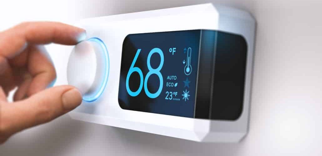hand adjusting digital thermostat