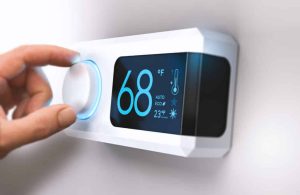 hand adjusting digital thermostat