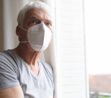 Senior wearing an air filter mask