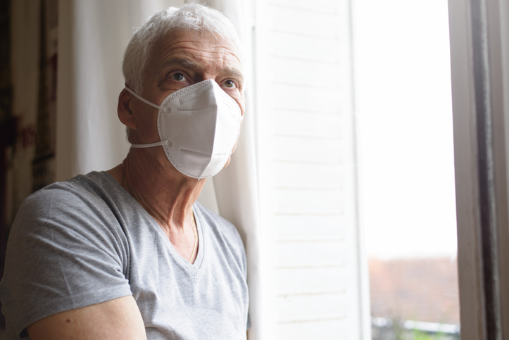 senior wearing an air filter mask