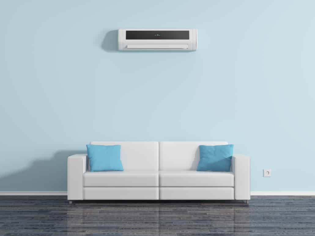 indoor ac unit on blue wall with couch