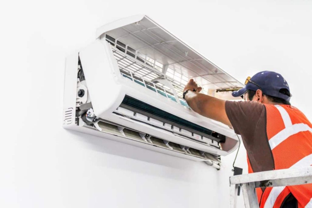 technician repairing ac unit