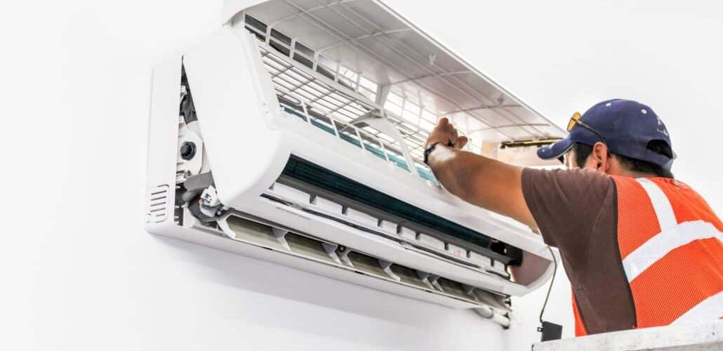 technician repairing ac unit