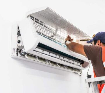 technician repairing ac unit
