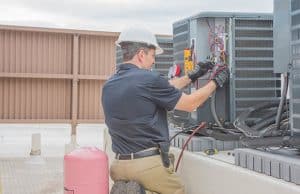 man working on ac unit