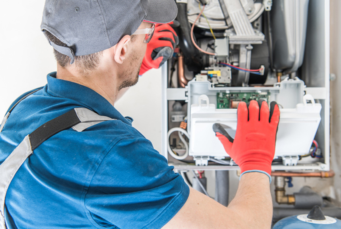 man working on furnace