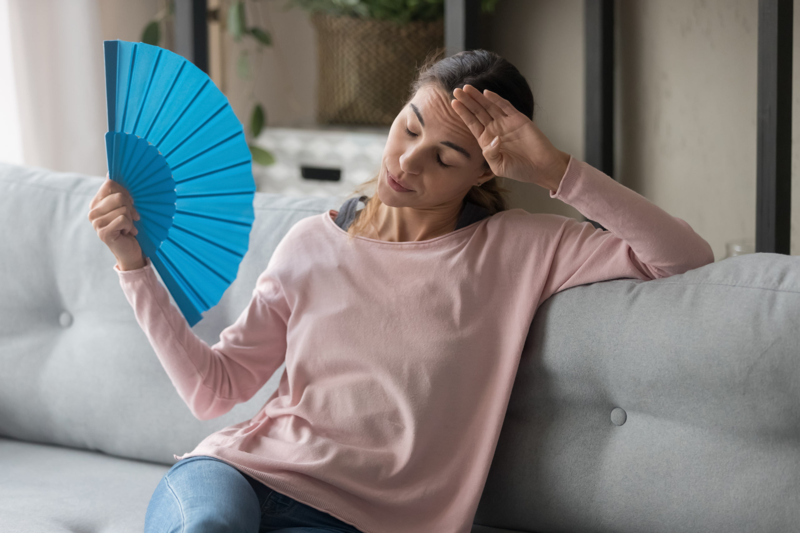 woman using blue fan