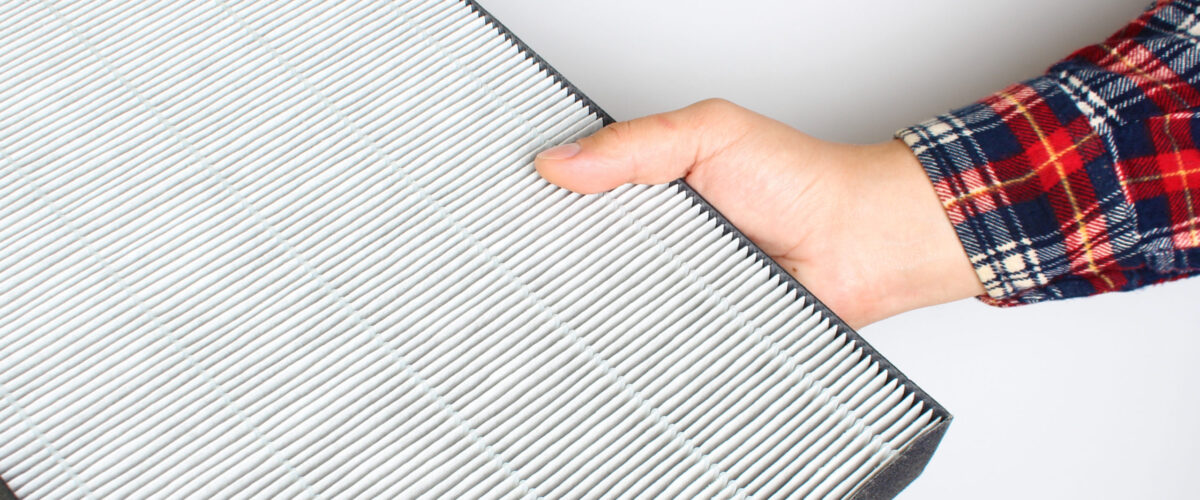 man holding air filter in hand