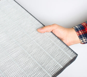 man holding air filter in hand