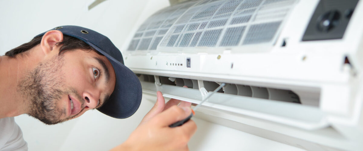 Man working on air conditioning unit