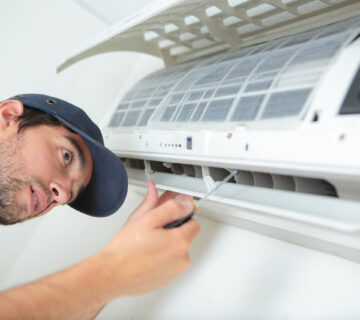 Man working on air conditioning unit