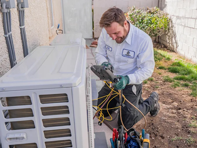 Legacy ac technician working on an air conditioning unit